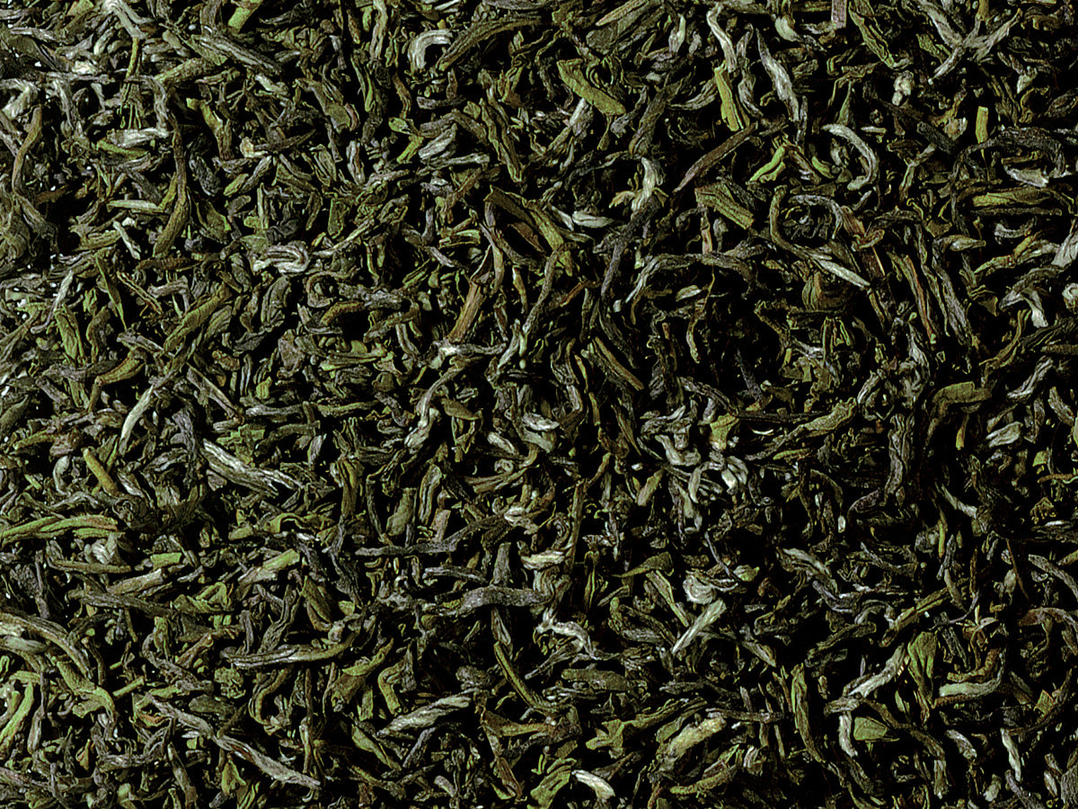 Organic Guranse Emerald green tea from Nepal with rolled green leaves, silvery tips, and a fresh, smooth floral character.