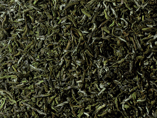 Organic Guranse Emerald green tea from Nepal with rolled green leaves, silvery tips, and a fresh, smooth floral character.