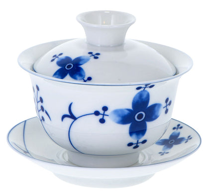 A white porcelain Gaiwan with blue floral patterns.