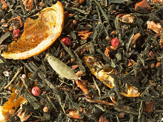 Sencha Orange Biscuits loose-leaf green tea blend with orange slices, apple, cinnamon, cardamom, cloves, coriander and pink pepper by Lunula Tea.