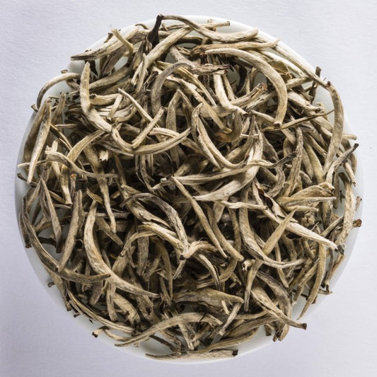 Yun Shan Yin Zhen loose-leaf Chinese yellow tea with slender downy buds and a clear golden infusion by Lunula Tea.